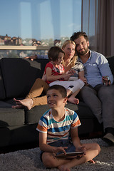 Image showing happy young couple spending time with kids at home