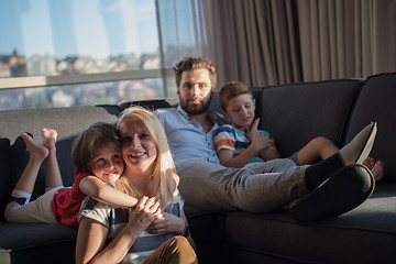 Image showing happy young couple spending time with kids at home