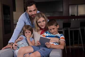 Image showing happy young couple spending time with kids