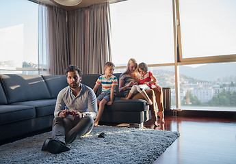 Image showing Happy family playing a video game