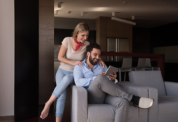 Image showing couple relaxing at  home with tablet computers