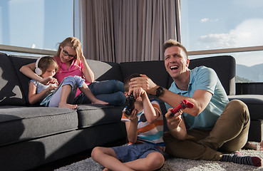 Image showing Happy family playing a video game