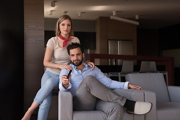 Image showing Young couple on the sofa watching television