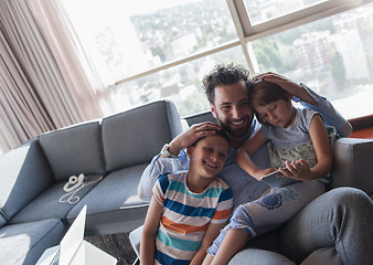 Image showing happy young father spending time with kids