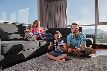 Image showing Happy family playing a video game