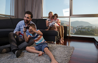 Image showing Happy family playing a video game