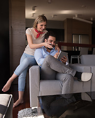 Image showing couple relaxing at  home with tablet computers