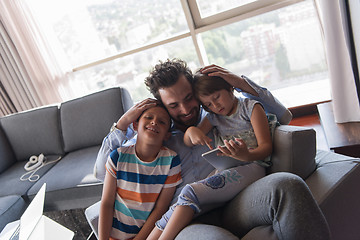 Image showing happy young father spending time with kids