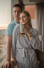 Image showing young couple enjoying evening coffee by the window