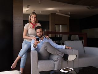 Image showing Young couple on the sofa watching television