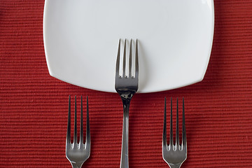 Image showing three forks and porcelain plate