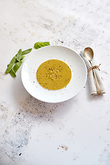 Image showing Creamy soup with green pea in a ceramic white plate