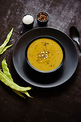 Image showing Creamy soup with green pea in a ceramic white plate