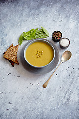 Image showing Green pea cream soup in grey bowl