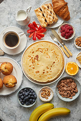 Image showing Various breakfast ingredients placed on stone table