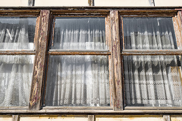 Image showing Worn old windows with vintage curtains