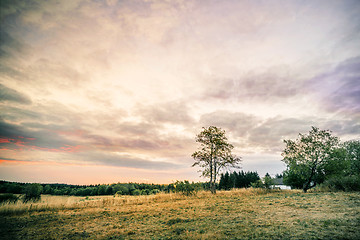 Image showing Sunset over a countryside landscape with a small house