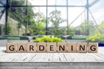 Image showing Gardening sign in a green house on a wooden