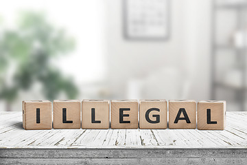 Image showing Illegal message on a wooden desk