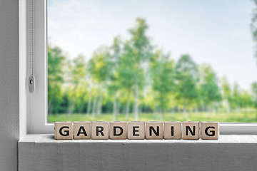 Image showing View to a garden in the spring with a gardening sign