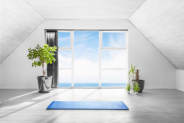 Image showing Indoor yoga scene with a blue mat in a bright room