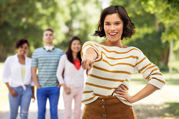 Image showing happy woman pointing finger to you at summer park