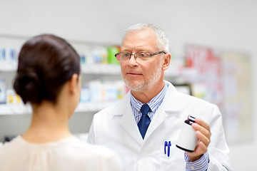 Image showing apothecary and woman with drug at pharmacy