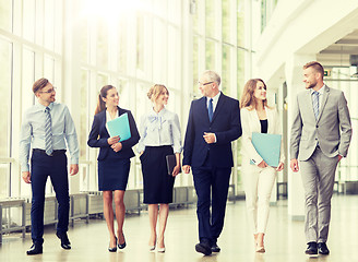 Image showing business people walking along office building