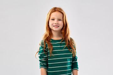 Image showing smiling red haired girl in striped shirt