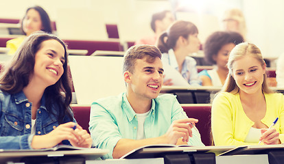 Image showing group of students with notebooks in lecture hall