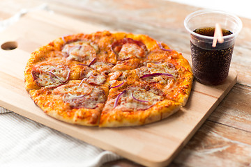 Image showing close up of homemade pizza with cola on table