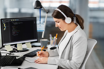 Image showing businesswoman with notebook working at office