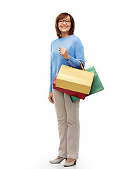 Image showing senior woman with shopping bags isolated on white