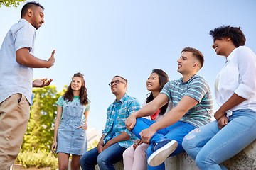 Image showing happy international friends talking in city