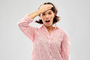 Image showing confused young woman in pajama