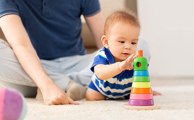 Image showing baby boy with father and pyramid toy at home