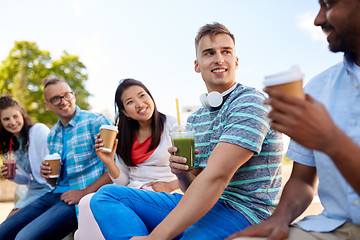 Image showing friends drinking coffee and juice talking in city