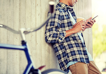 Image showing man with earphones and smartphone listening music