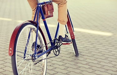 Image showing close up of hipster man riding fixed gear bike