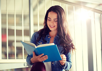 Image showing high school student girl reading book at library