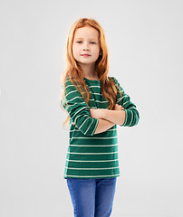 Image showing confident red haired girl posing with crossed arms