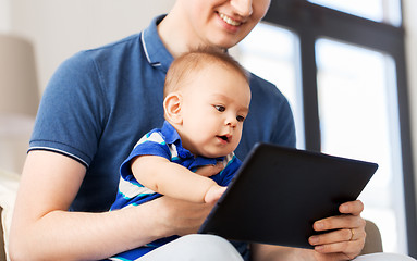 Image showing happy father and baby son with tablet pc at home