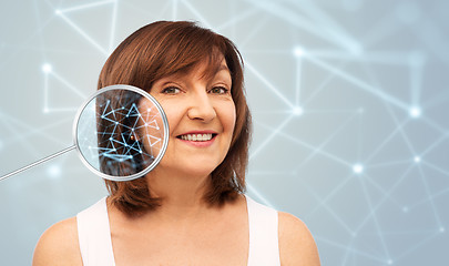 Image showing senior woman with low poly grid in magnifier