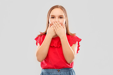 Image showing confused girl covering her mouth by hands