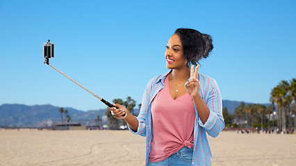 Image showing african american woman taking selfie by smartphone