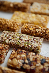 Image showing Close up on healthy granola fit bars arragement. Placed on white table
