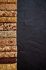 Image showing Row of mixed gluten free granola cereal energy bars. With dried 