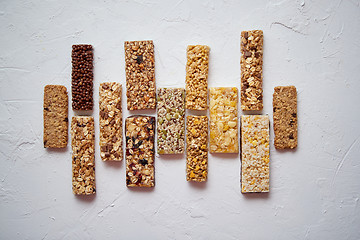 Image showing Row of mixed gluten free granola cereal energy bars. With dried fruits and nuts.