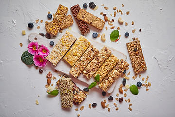 Image showing Various kinds of protein granola bars with dry fruits and berries