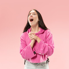 Image showing Beautiful woman looking suprised isolated on pink